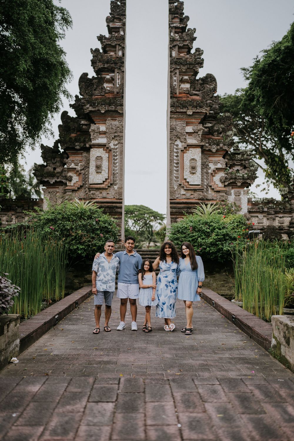 Family photoshoot experience at Nusa Dua Beach Hotel Bali with seaside backdrop.