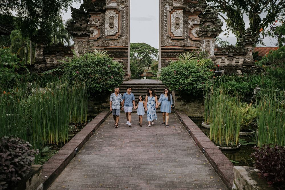 Family photoshoot experience at Nusa Dua Beach Hotel Bali with seaside backdrop.