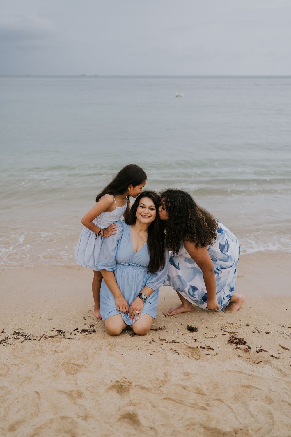 Family photoshoot experience at Nusa Dua Beach Hotel Bali with seaside backdrop.