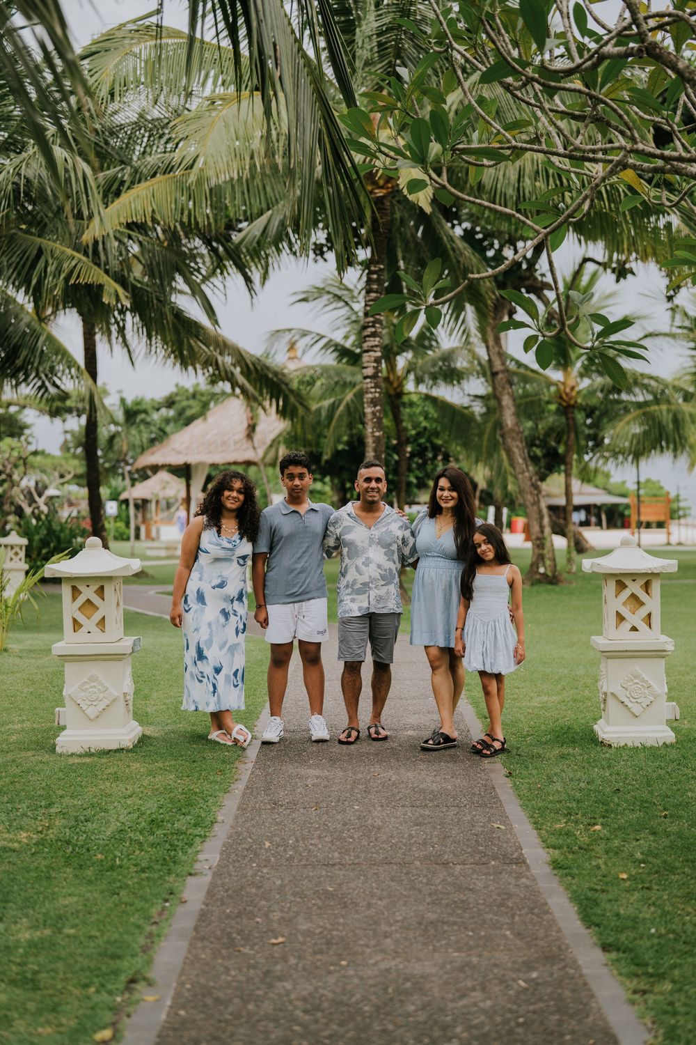 Family photoshoot experience at Nusa Dua Beach Hotel Bali with seaside backdrop.