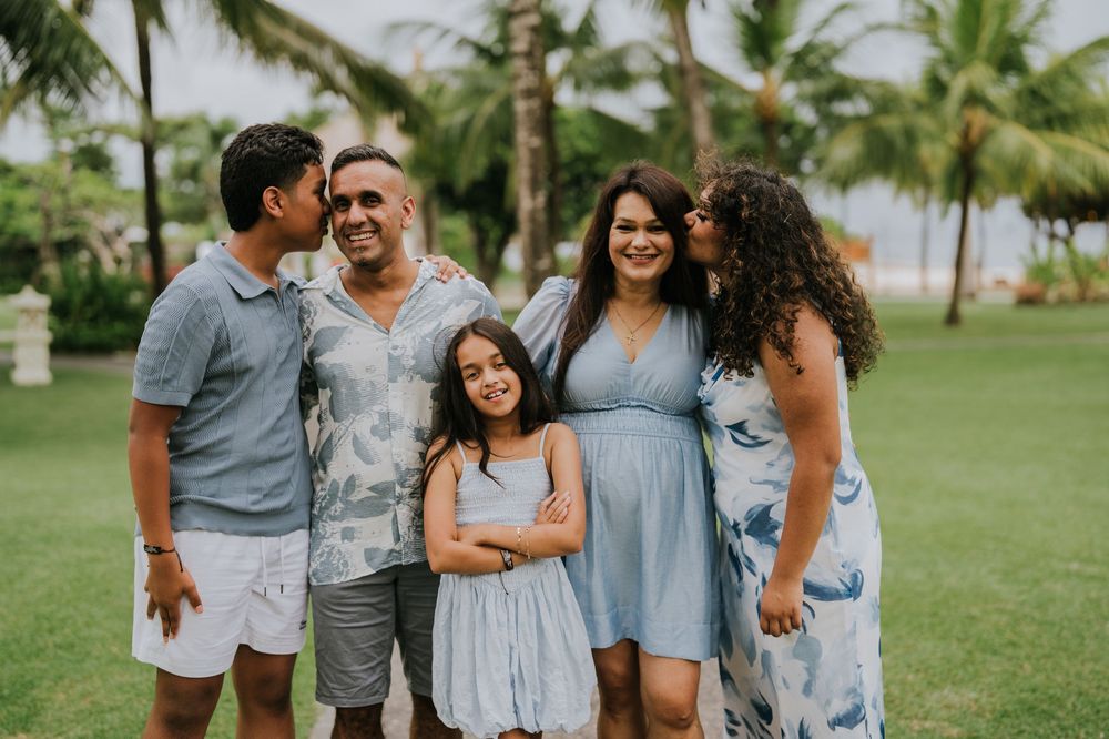 Family photoshoot experience at Nusa Dua Beach Hotel Bali with seaside backdrop.