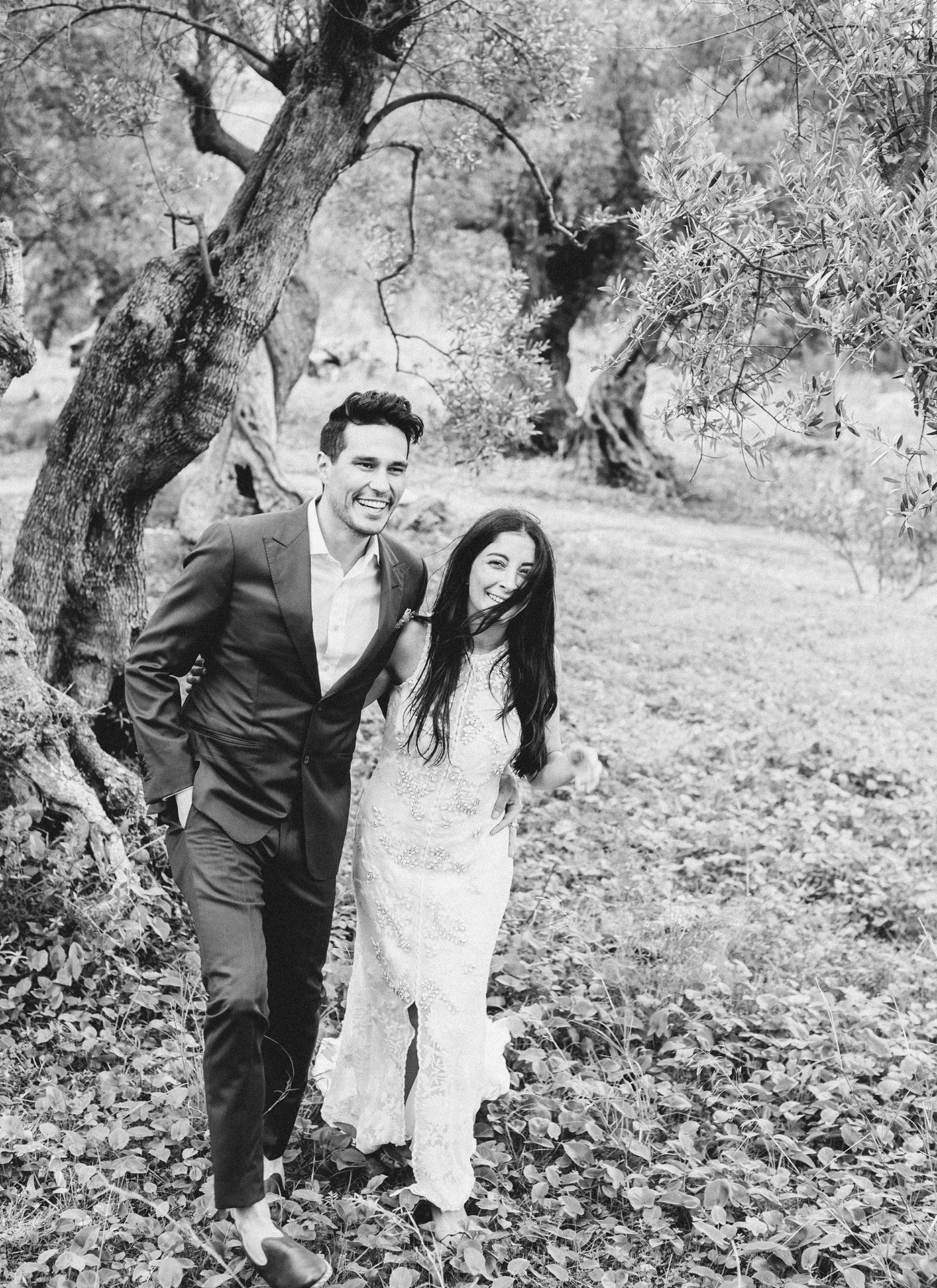 Wedding couple walking through olive grove in Mallorca