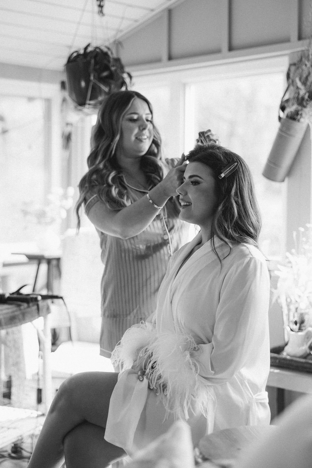 Wedding preparation scene showing styling and getting ready moments in a bright white room.
