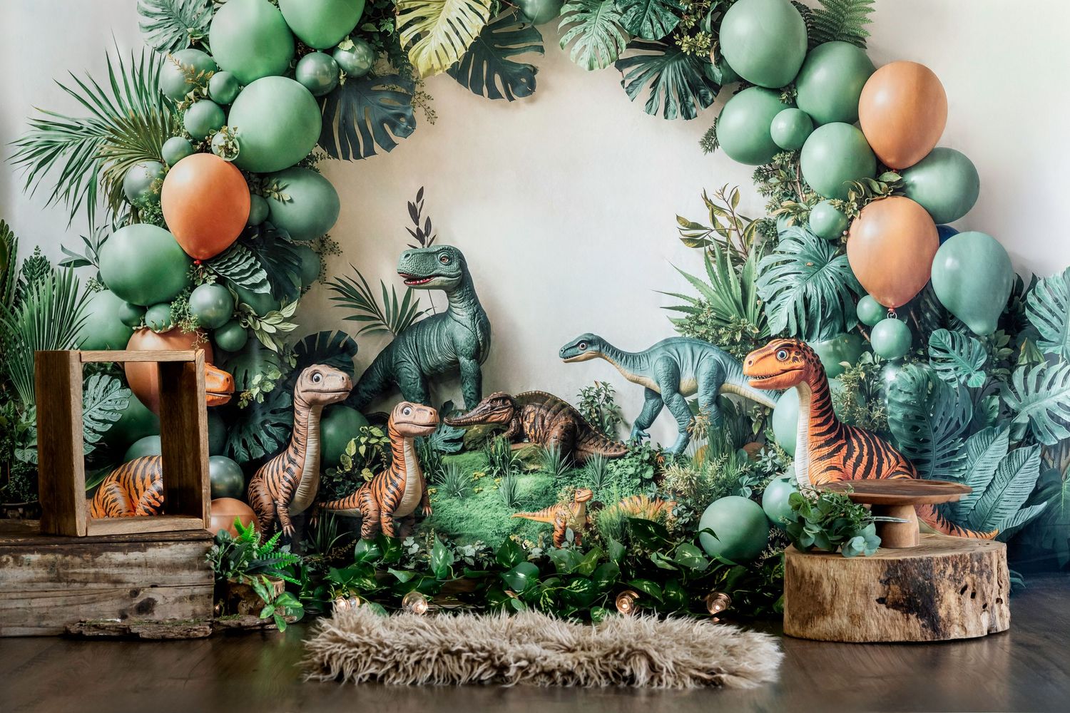 Tropical party setup with green balloons, palm leaves, and peach accents against white backdrop.Suitable for Smash & Splash photography.