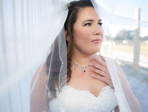 Elegant bridal portraits against white curtains with natural window lighting.