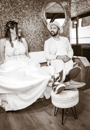 Black and white photos of a couple posing in formal attire against a textured wall.