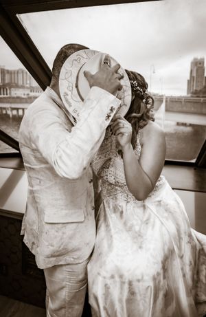Black and white romantic photos capturing intimate moments on a boat with city views.