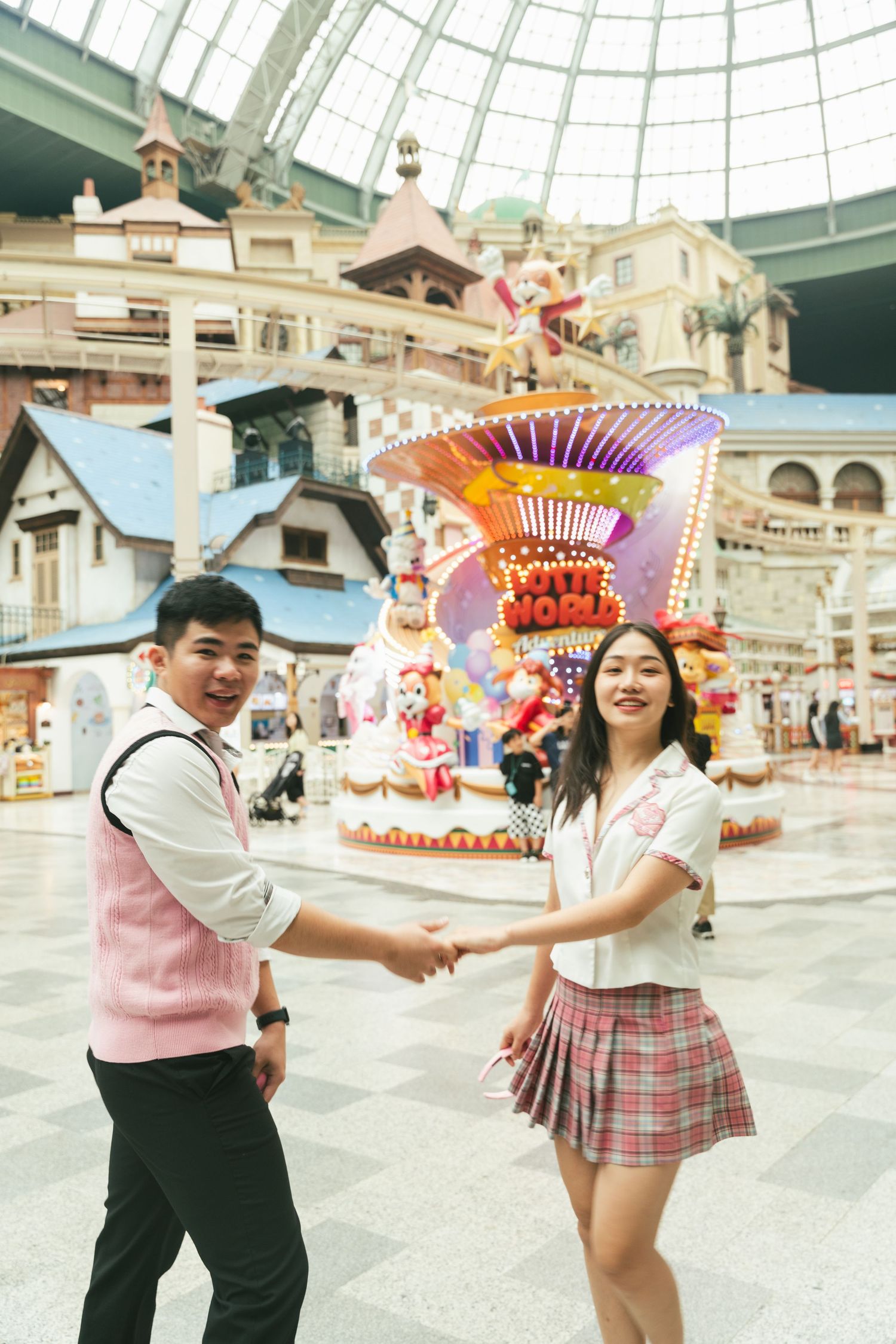 Two people dancing together in a bright indoor space with decorative fans and traditional Japanese-style architecture.