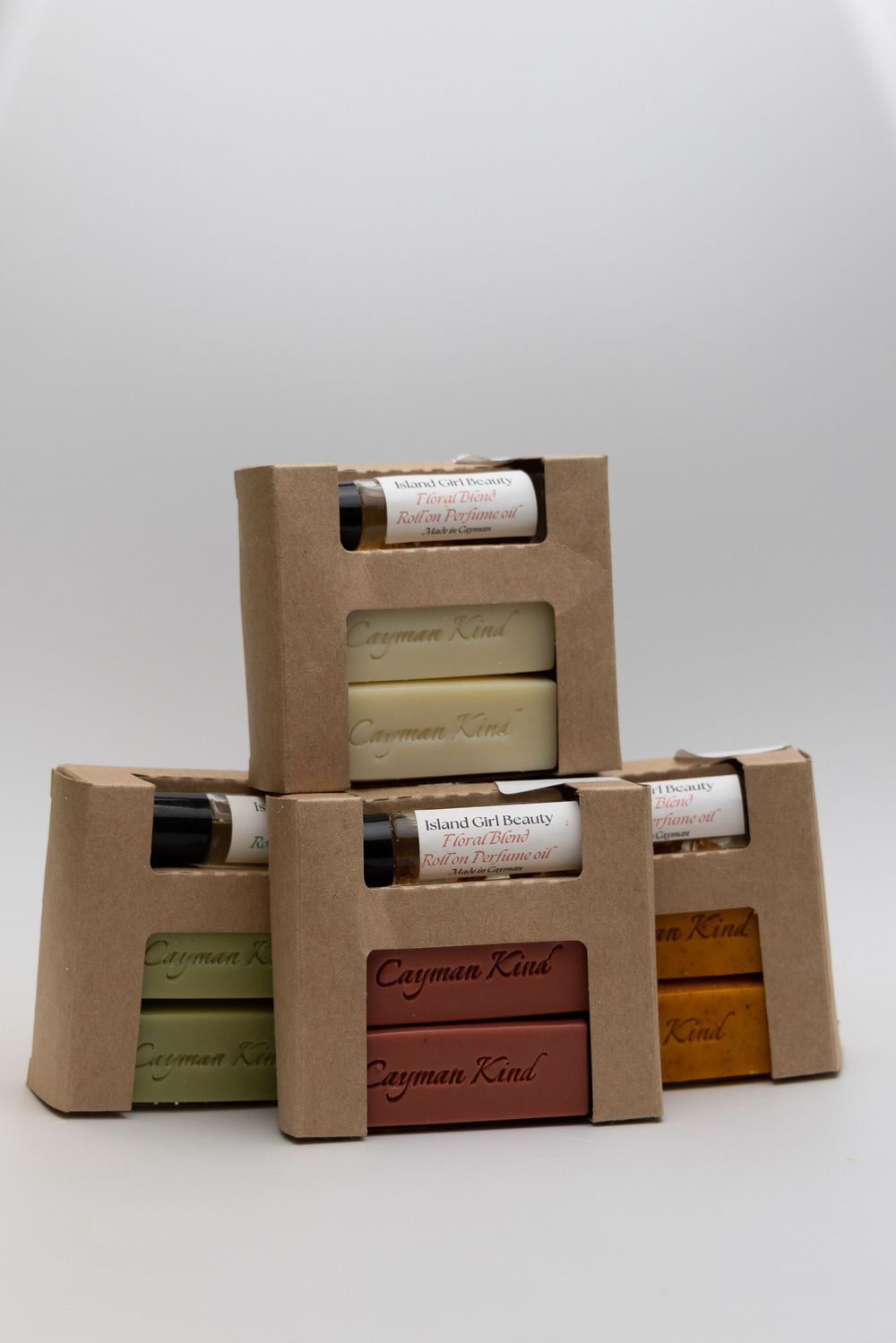 Collection of eco-friendly kraft paper product boxes with Cayman Kind branding in various sizes.