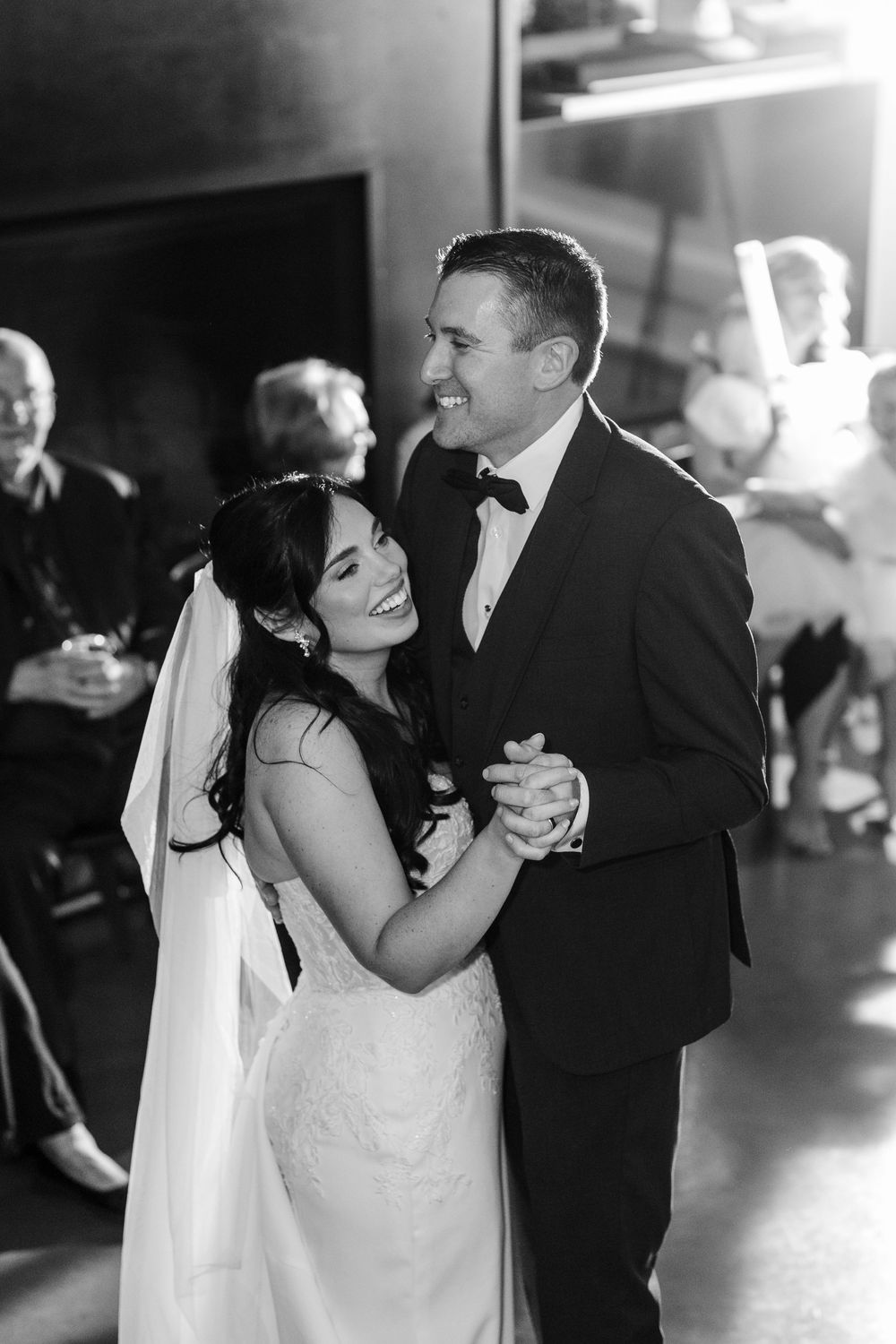 A series of black and white photos showing a couple's romantic first dance at their wedding reception.