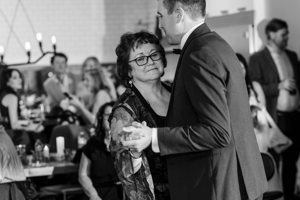 A black and white collage of people at a business event shows various attendees engaged in conversation and networking.