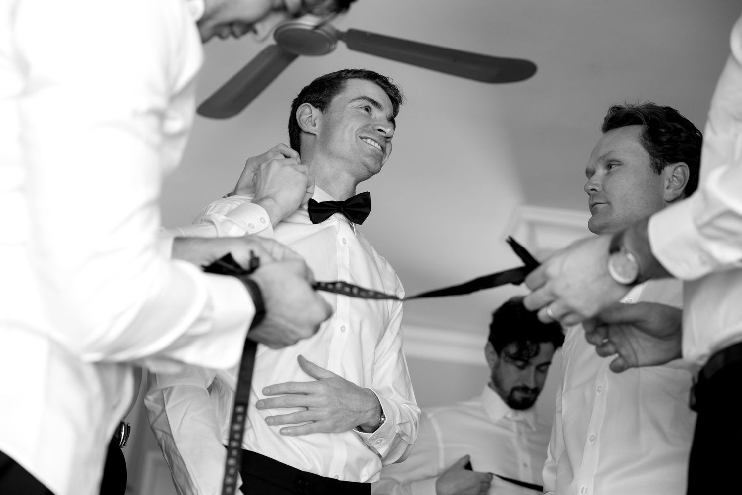 Two people in formal attire dance together in black and white, creating an elegant vintage scene.