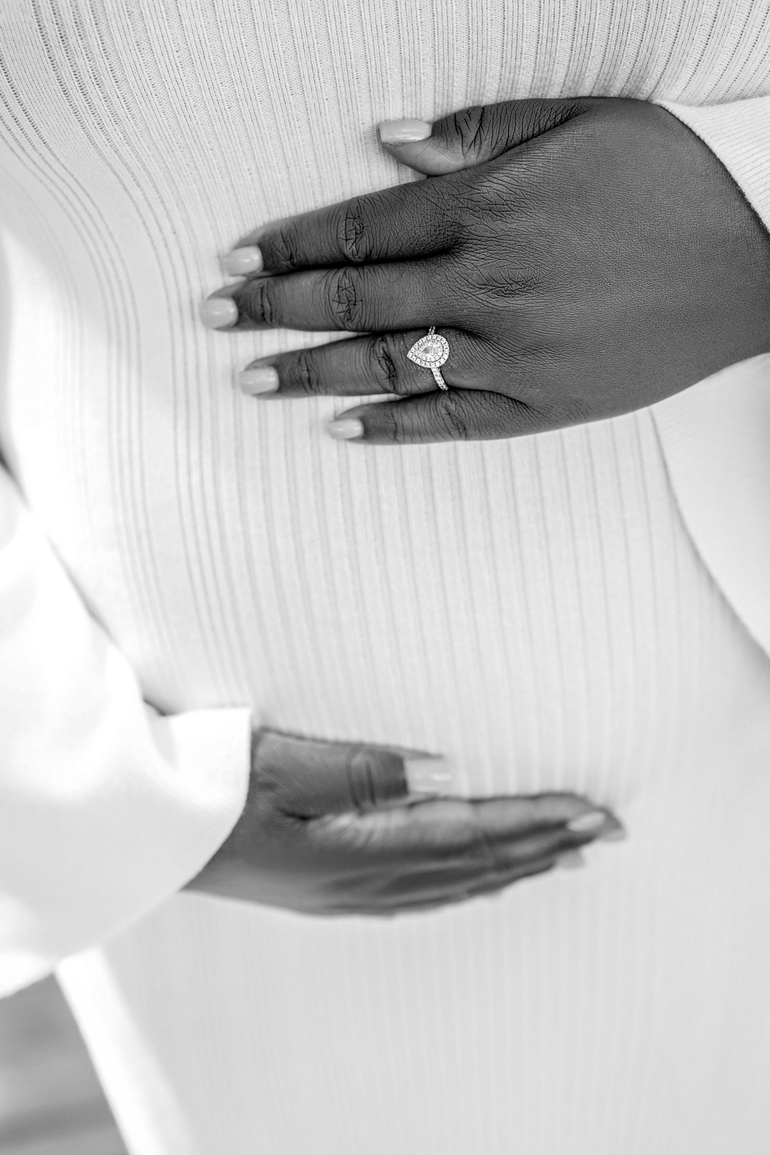 A sequence of black and white photos showing hands with engagement rings against a white textured background.