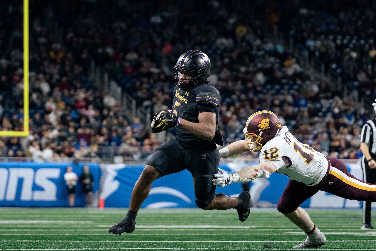 Caleb Komolafe breaking a tackle on his way to the end zone, Northwestern vs Central Michigan, Ford Field, Detroit MI, 12/26/25