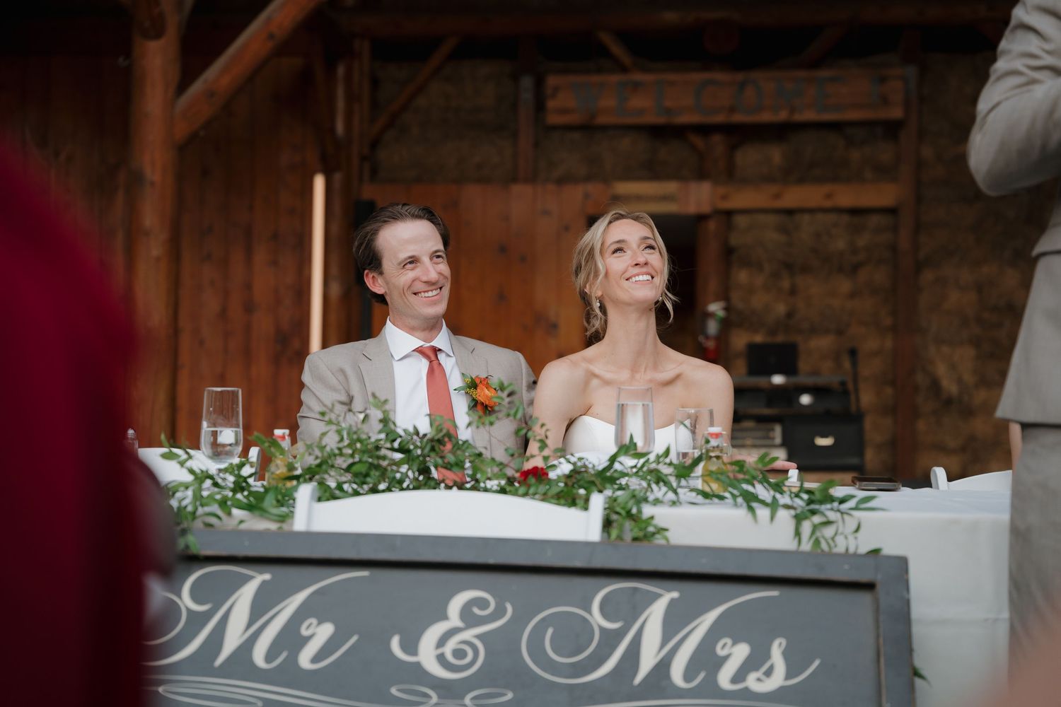 Rustic barn wedding reception setup with elegant table decor and romantic lighting throughout the venue.