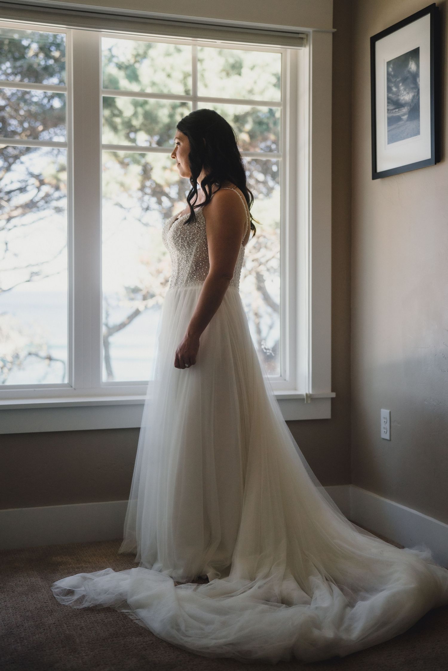 A series of four connected photos showing a white wedding dress with flowing tulle skirt in a sunlit room with windows.