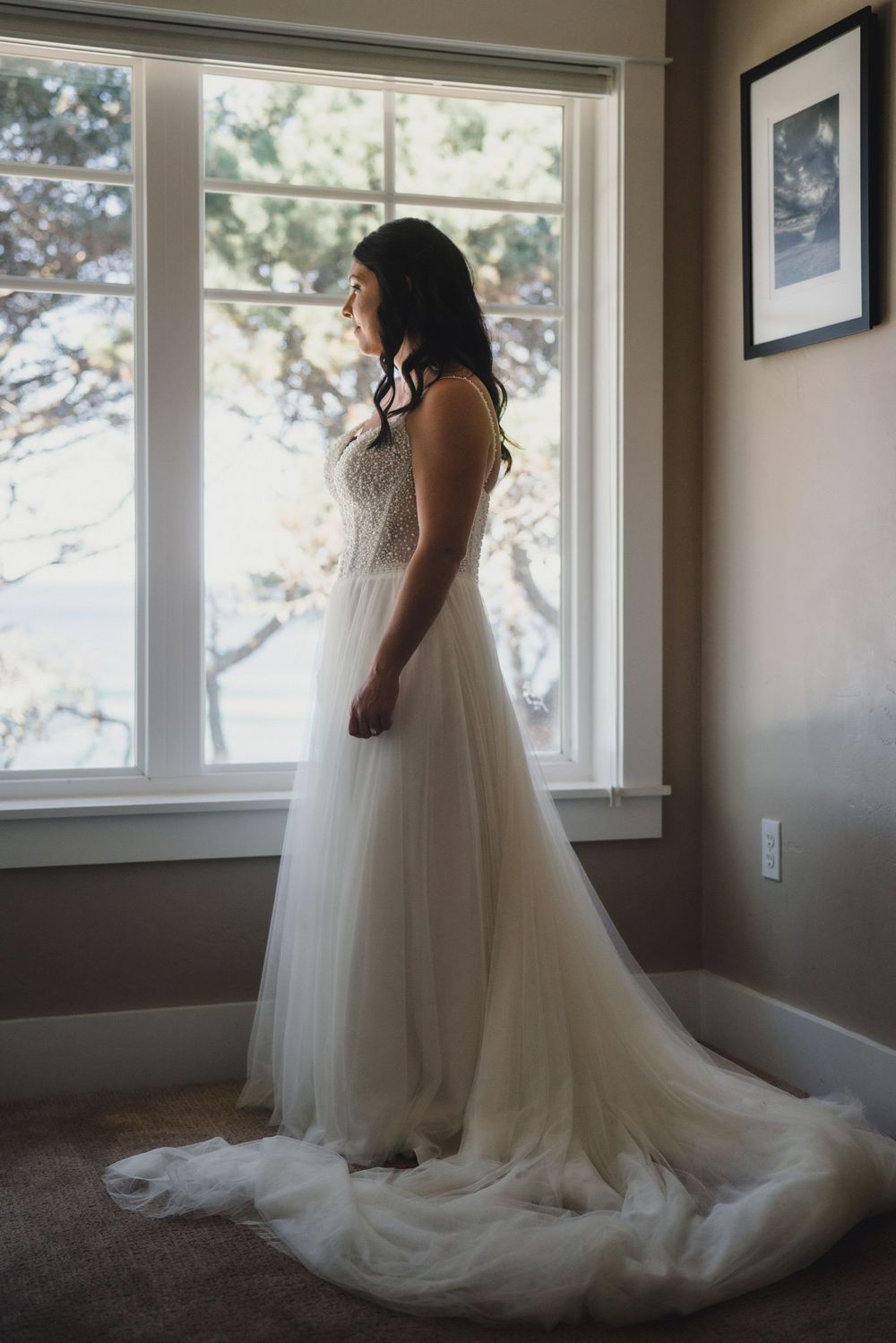 A series of four connected photos showing a white wedding dress with flowing tulle skirt in a sunlit room with windows.