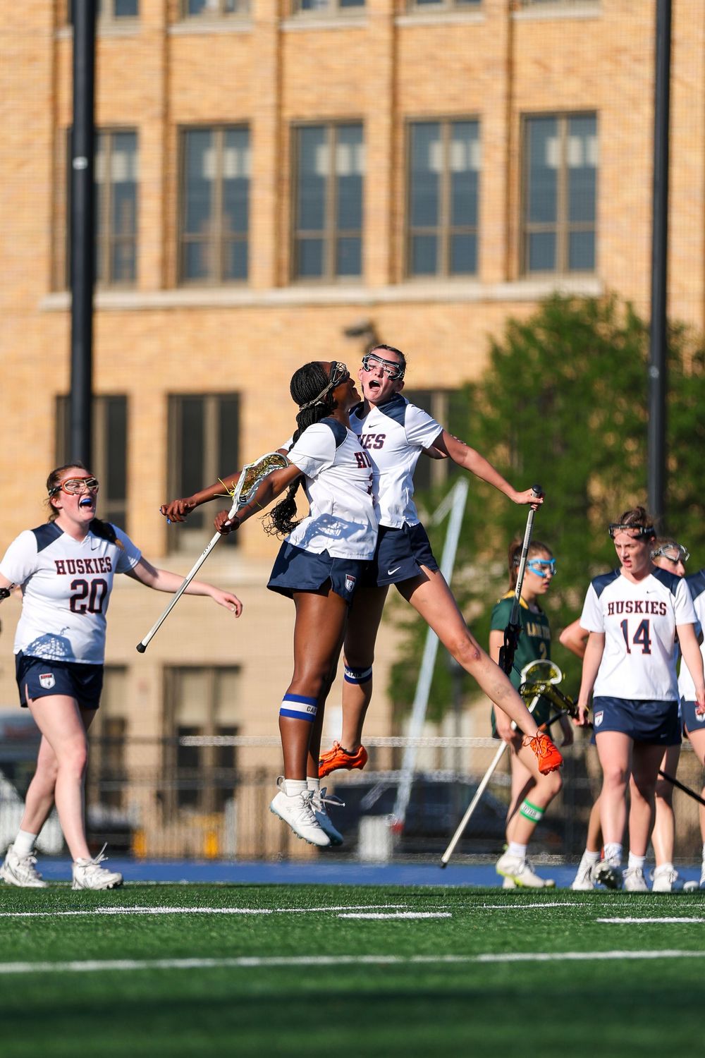 Team members performing dynamic stretches during outdoor practice session.