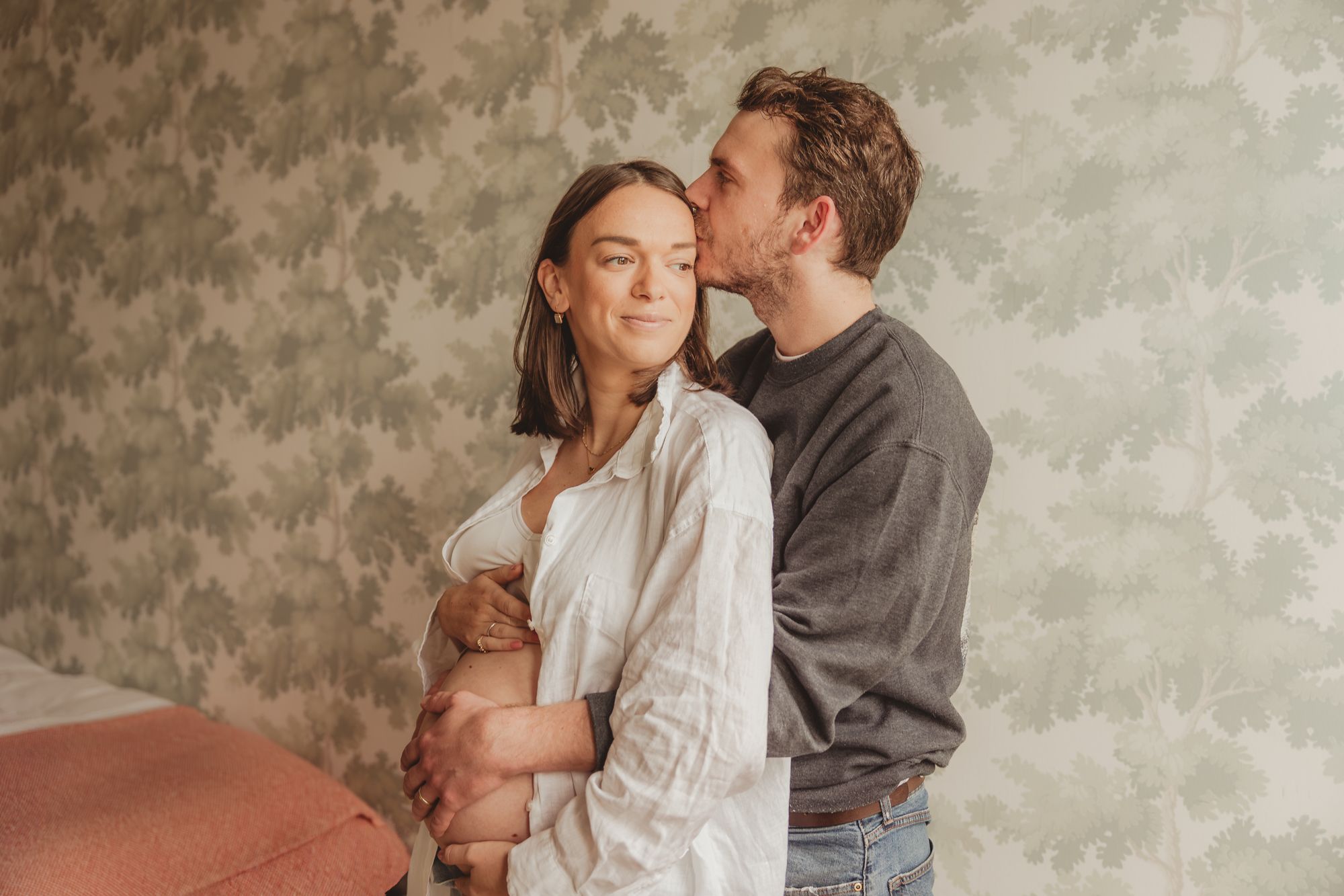 A romantic couple shares tender moments in a series of intimate poses against a neutral backdrop.