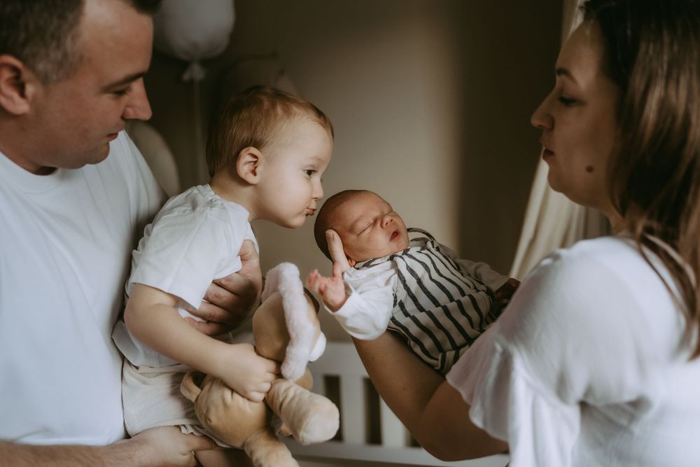 Intimate family portrait showing gentle moments of connection in soft lighting.