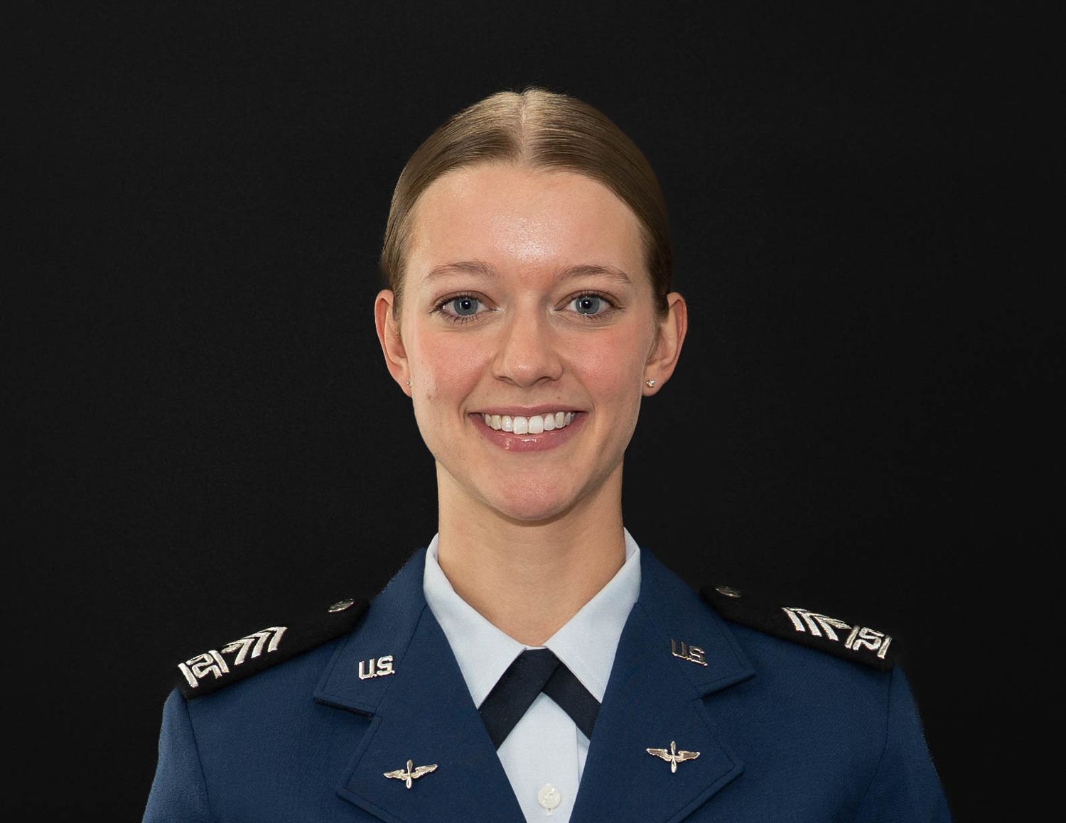 A series of military headshots showing uniformed service members in dress blues with white collars.