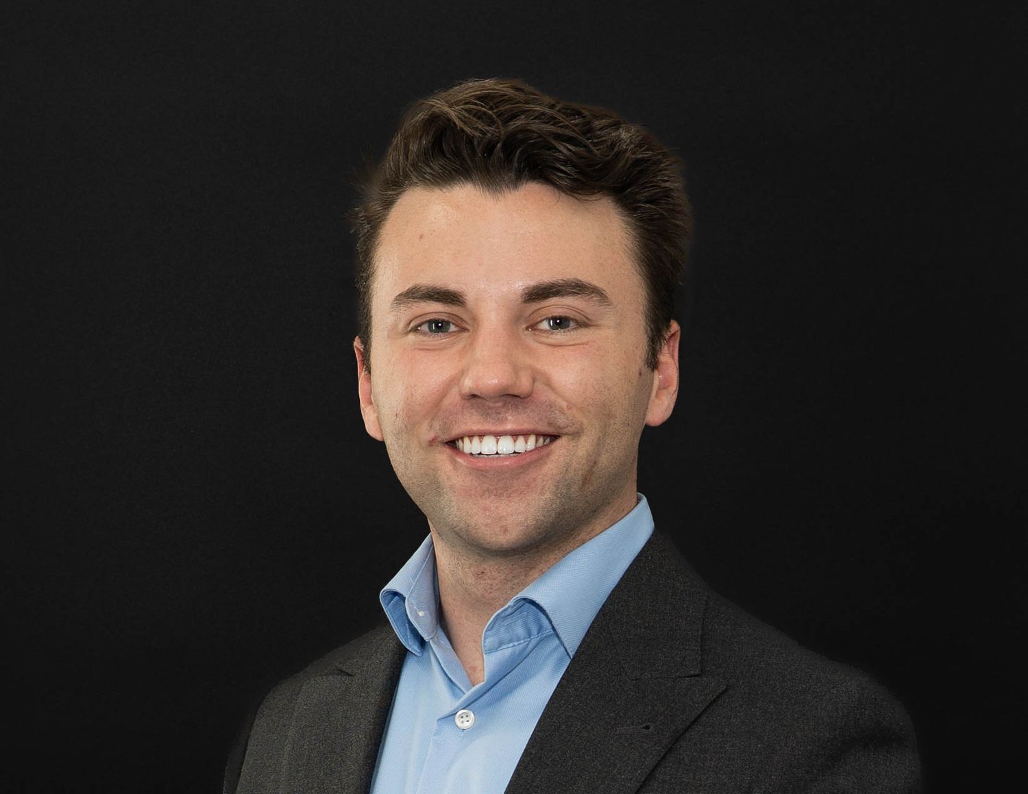 Professional headshot series of someone in business attire against dark background.