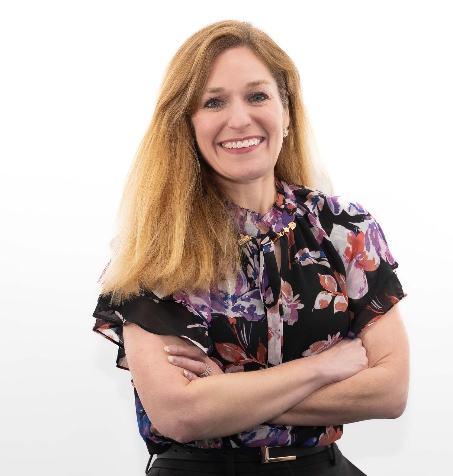 Professional headshot series of someone in a black floral top showing different expressions and poses against white background.