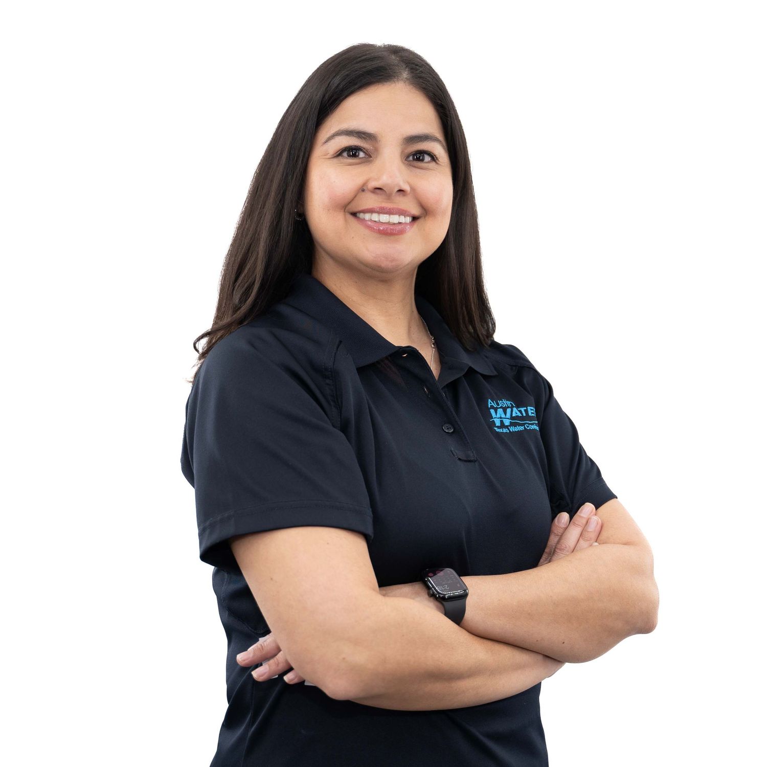 Professional staff member in black polo shirt standing with arms crossed and friendly expression.