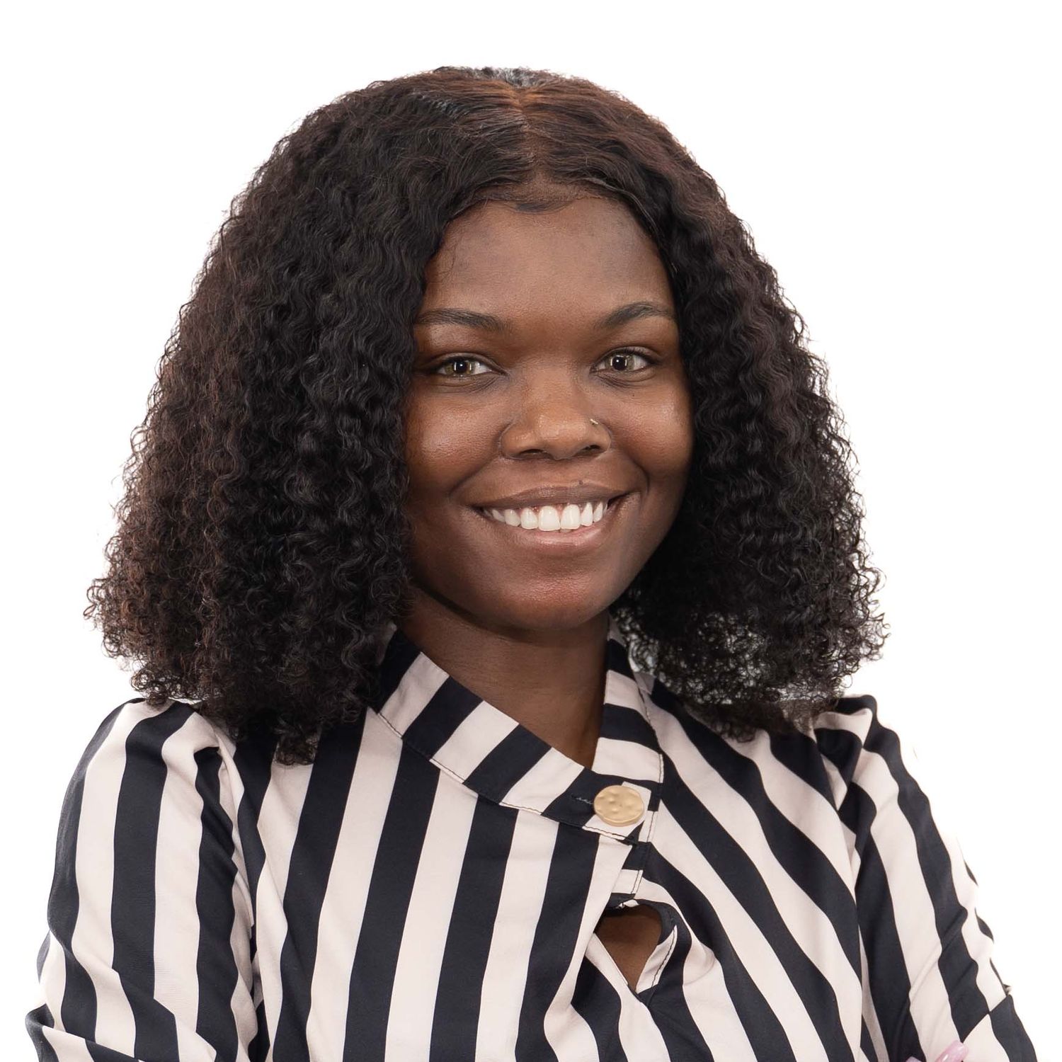 Person wearing black and white striped collared shirt smiles warmly in professional headshot series.