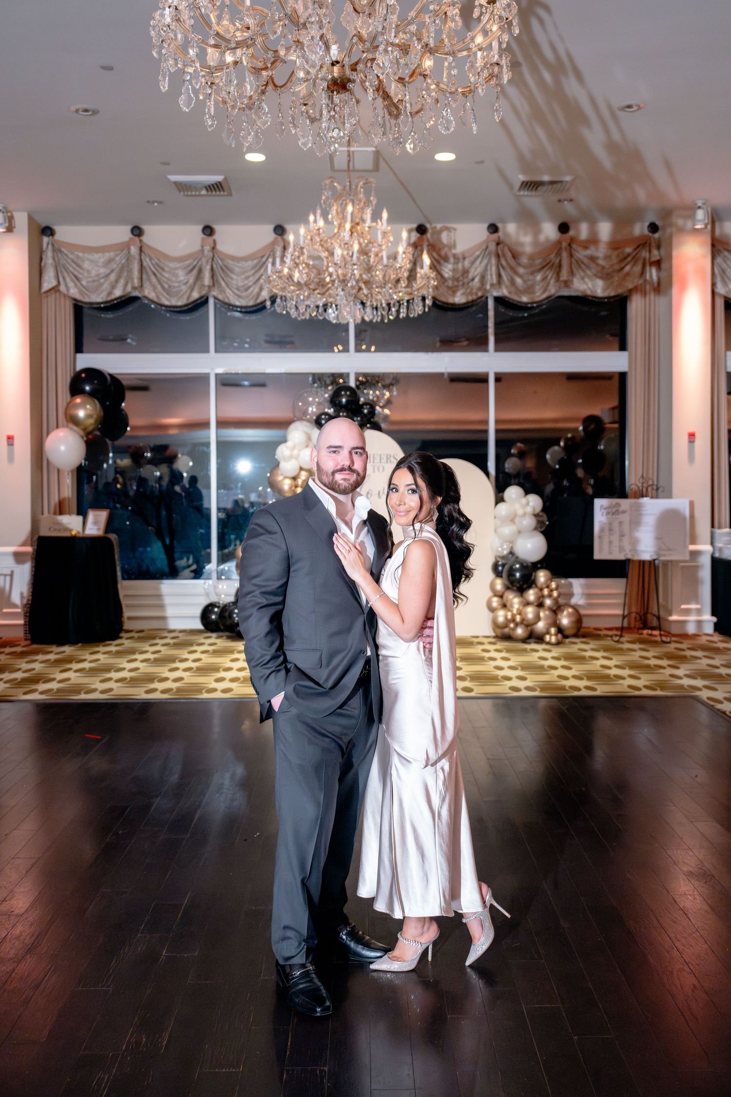 Elegant ballroom with crystal chandeliers and dark hardwood dance floor.