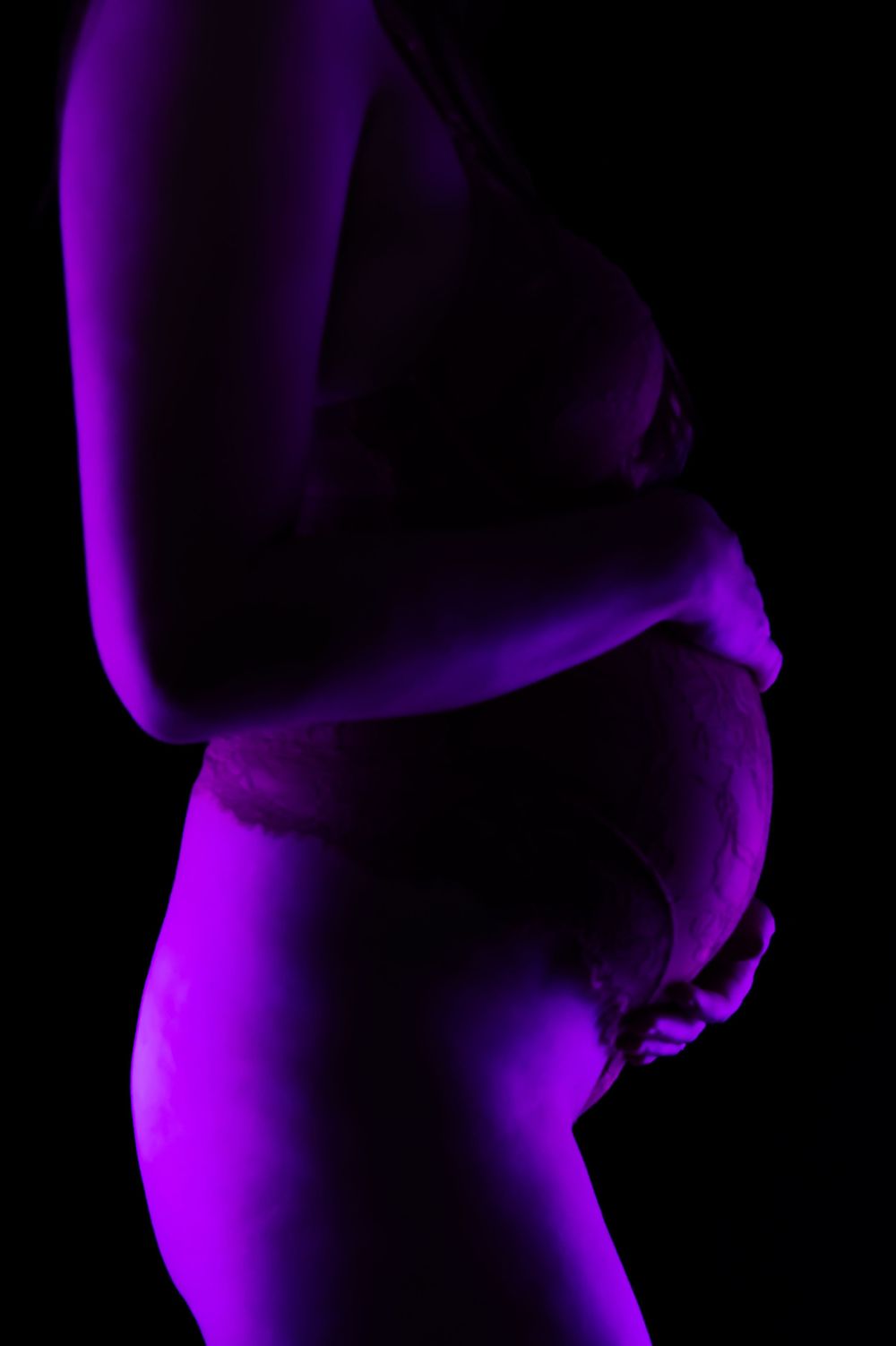 Abstract purple gradient shapes create a mesmerizing pattern against a dark background.
