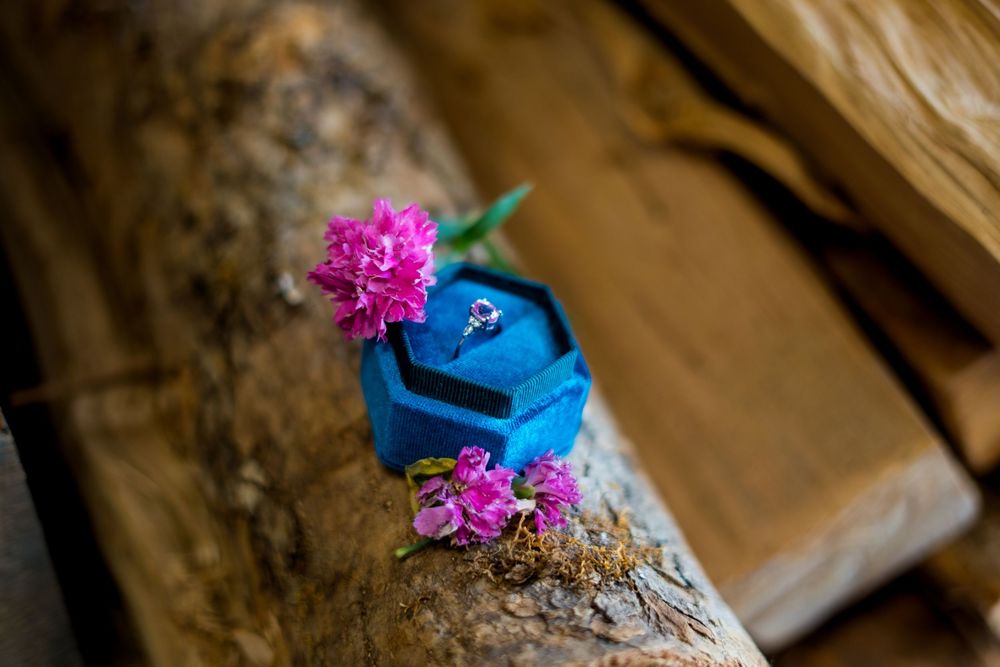 Vibrant pink flowers and blue decorative elements arranged as wedding details.