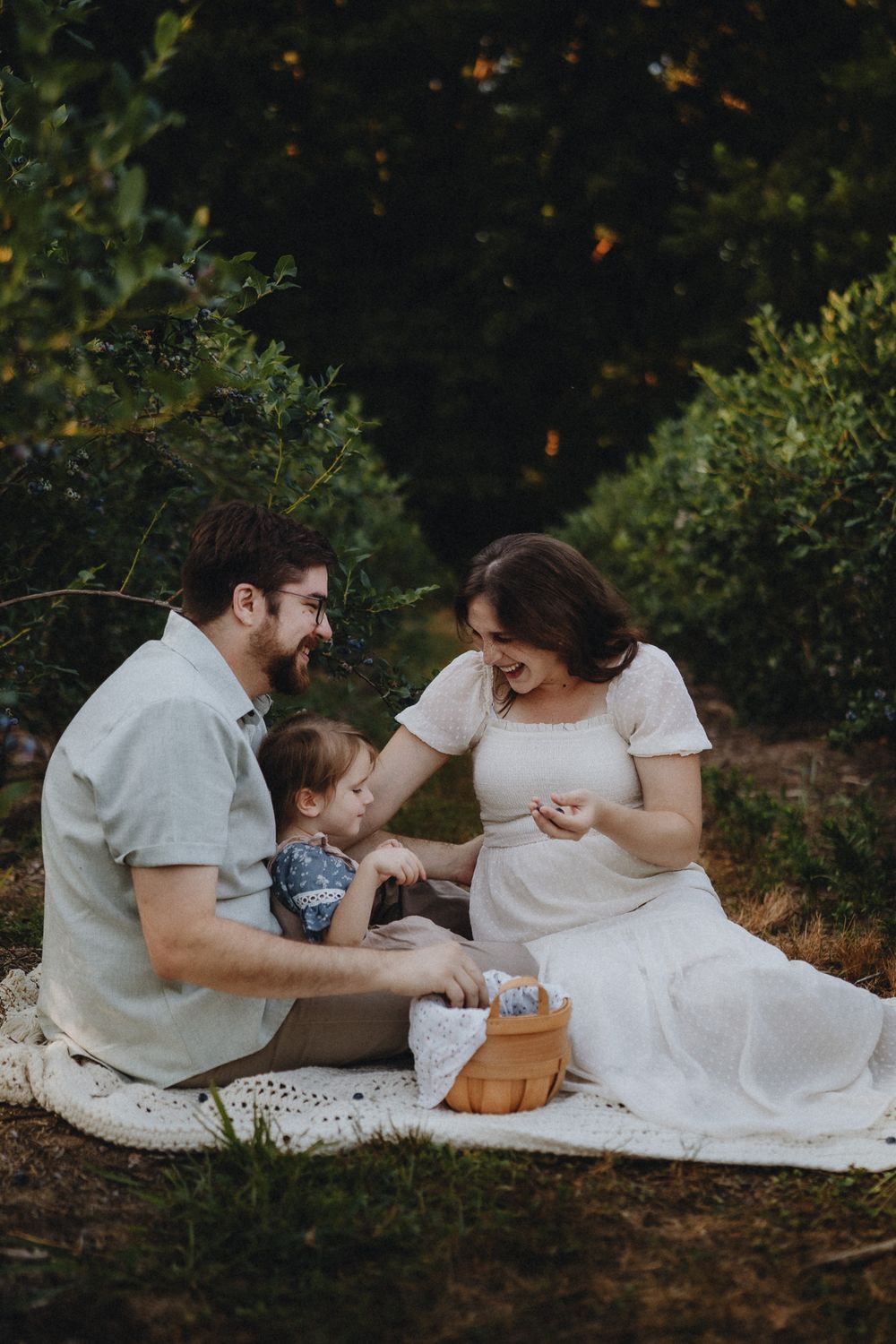 A loving family moment captured during a casual outdoor photo session in nature.