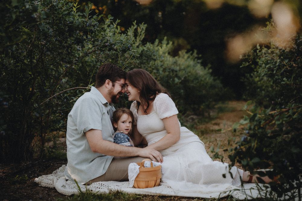 An intimate family portrait session set against a natural wooded backdrop.