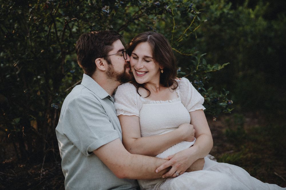 An intimate family embrace captured during an outdoor photography session.