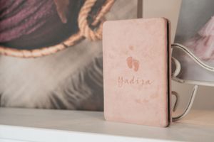 Elegant photo album presentation with soft pink branding elements.
