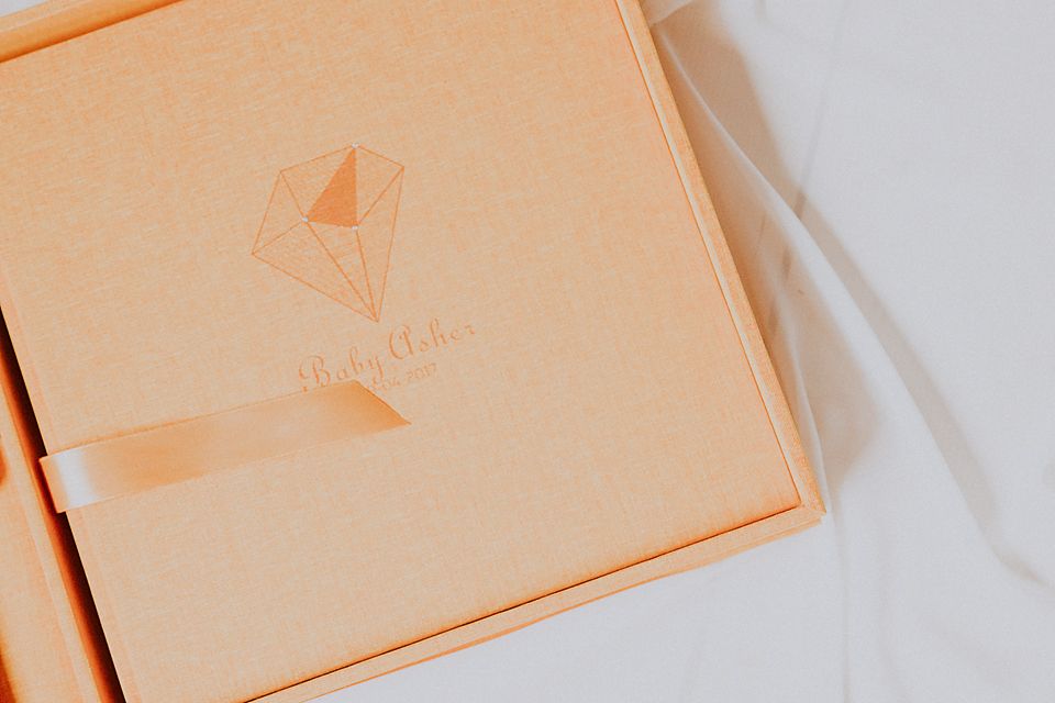 Orange-tinted product packaging boxes photographed in a minimalist style against a white background.
