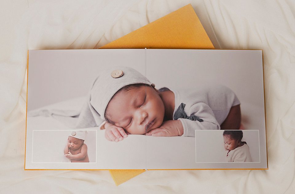Peaceful sleeping baby portrait displayed in a modern photo album layout.