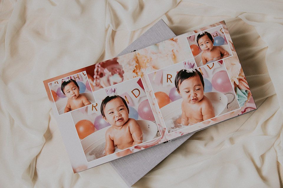 Multiple photo prints arranged on white textile surface showing family moments.