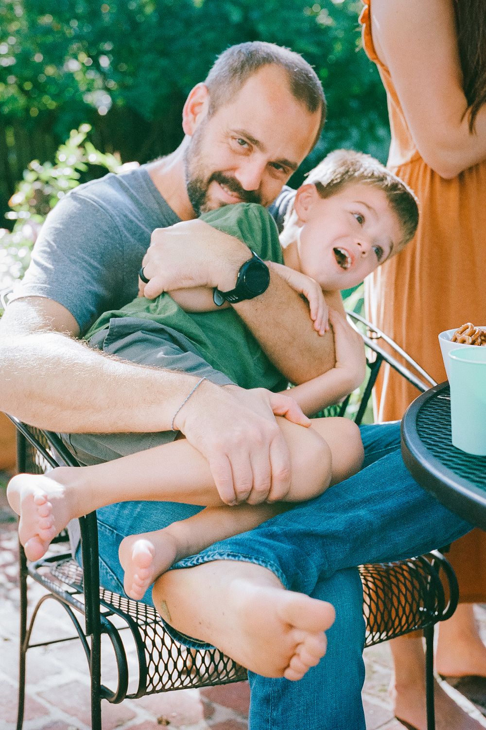 A playful moment shared on an outdoor patio with laughter and joy.