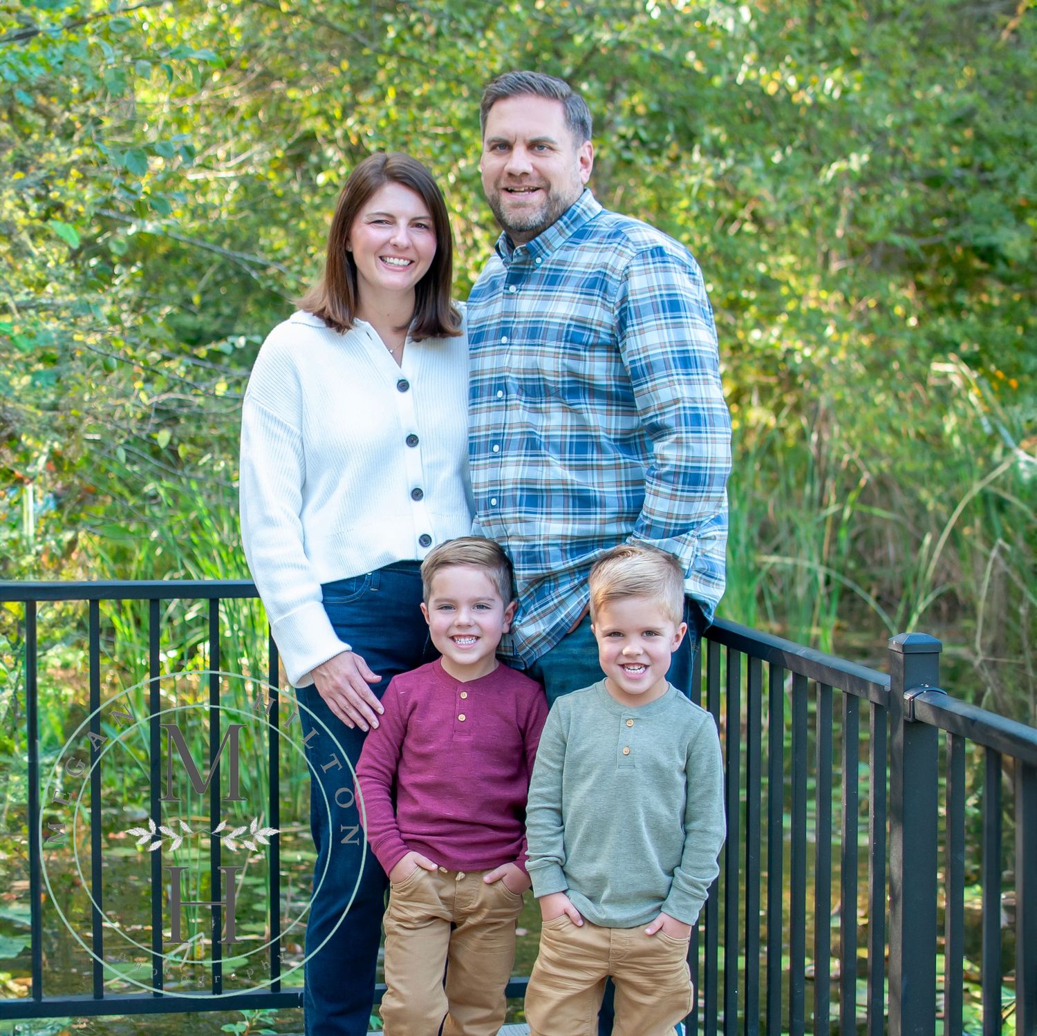 Family standing near pond photo