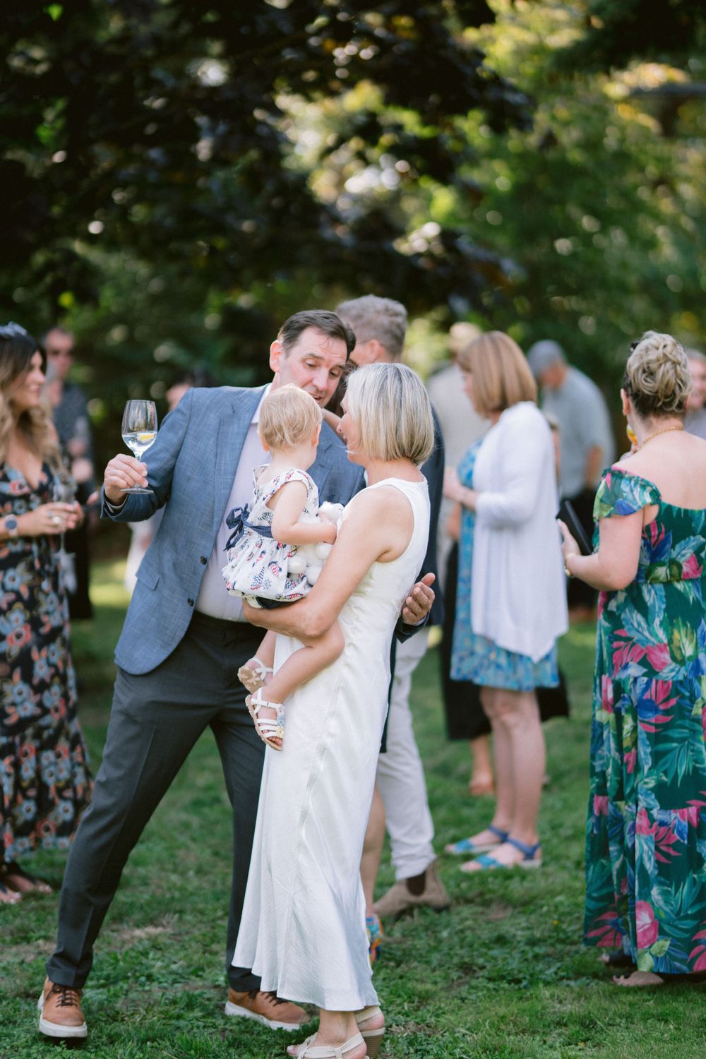 Guests enjoying drinks and conversation at an outdoor garden party.