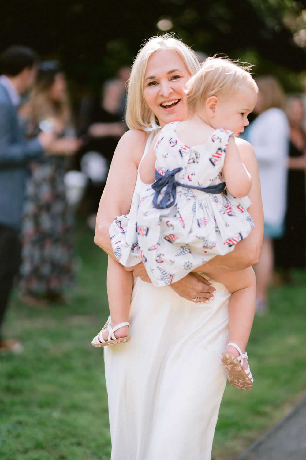 Joyful moment at an outdoor celebration with floral summer dresses and casual attire.