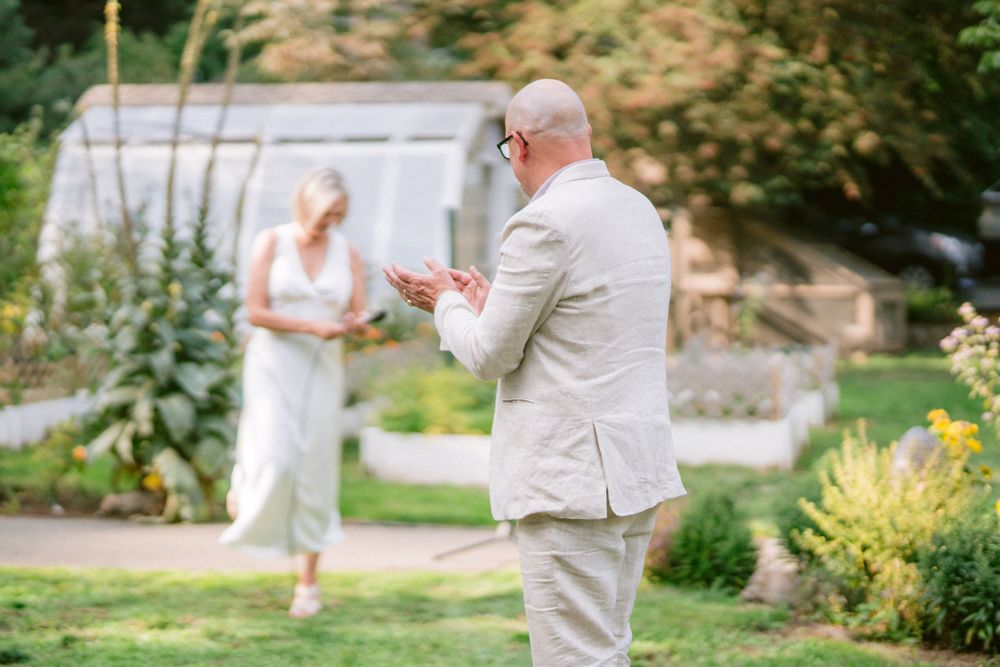 A couple exchanges vows during an intimate garden wedding ceremony.