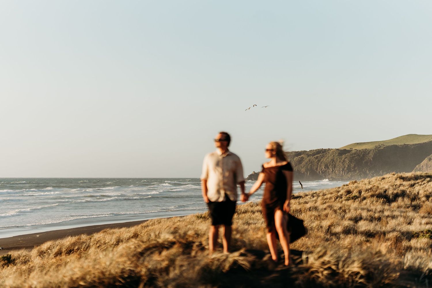 landscape-photo-at-beach-with-engaged-couple-holding-hands-creative-photo