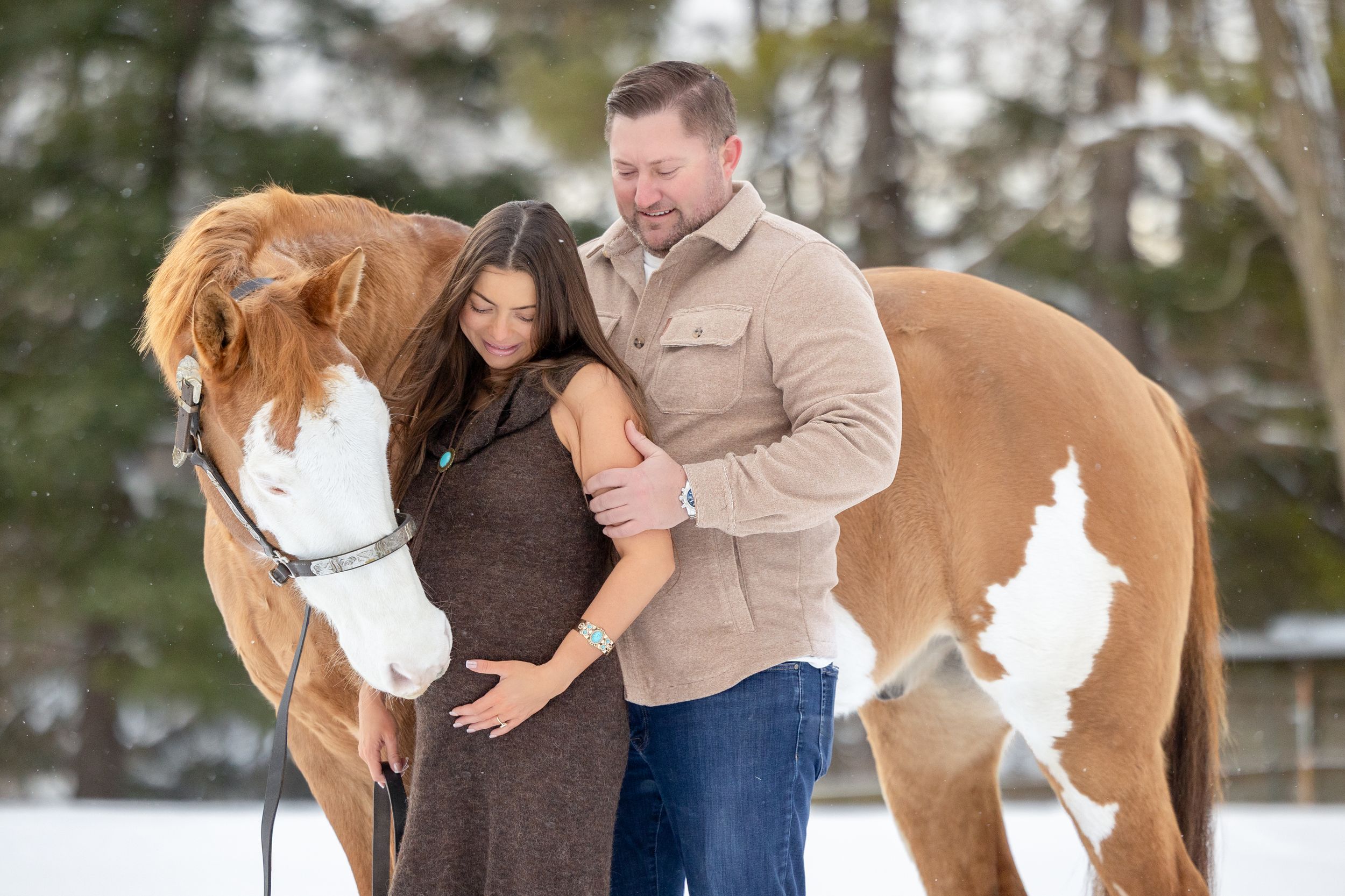 couple with horse in the snow