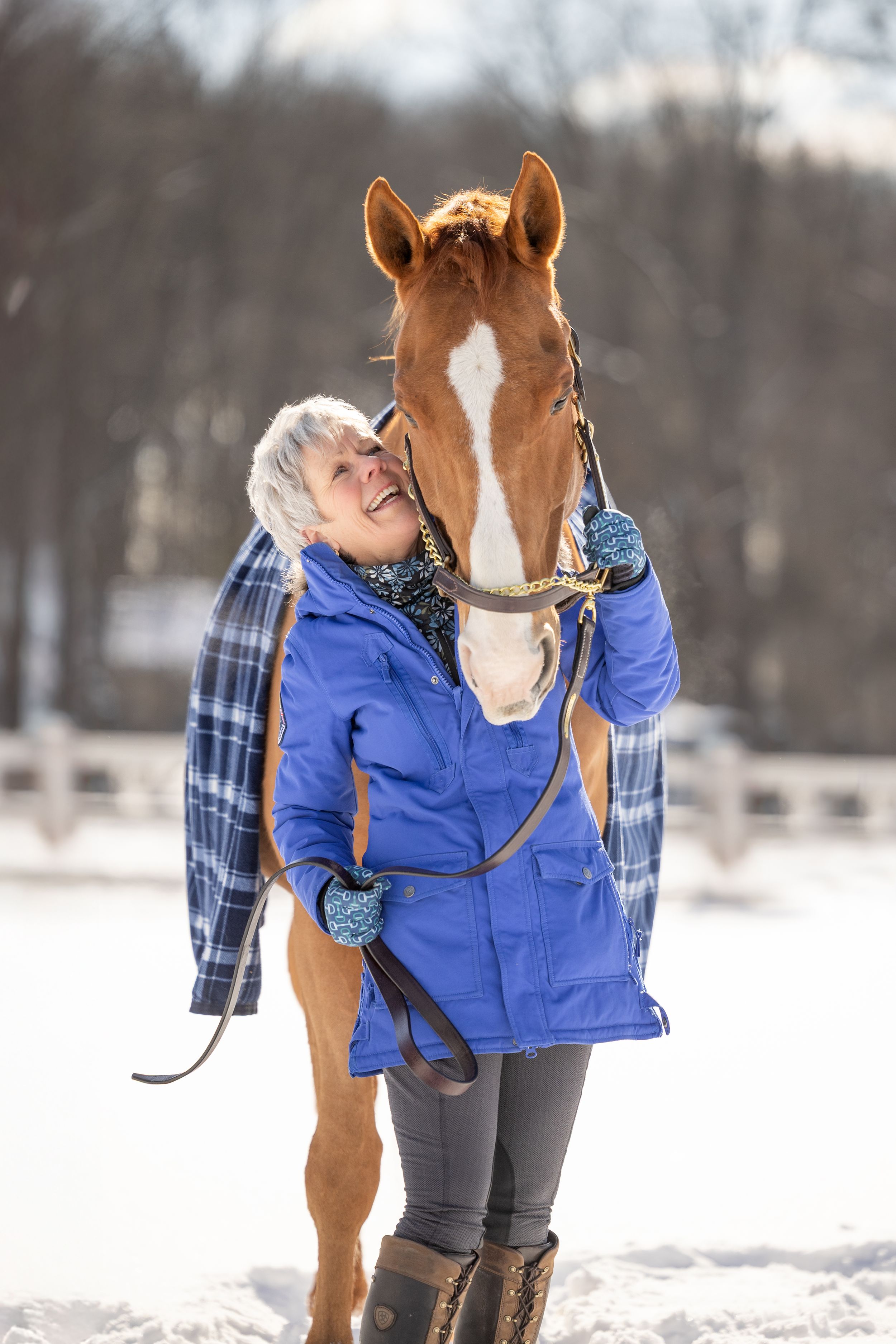 woman with horse in the snow