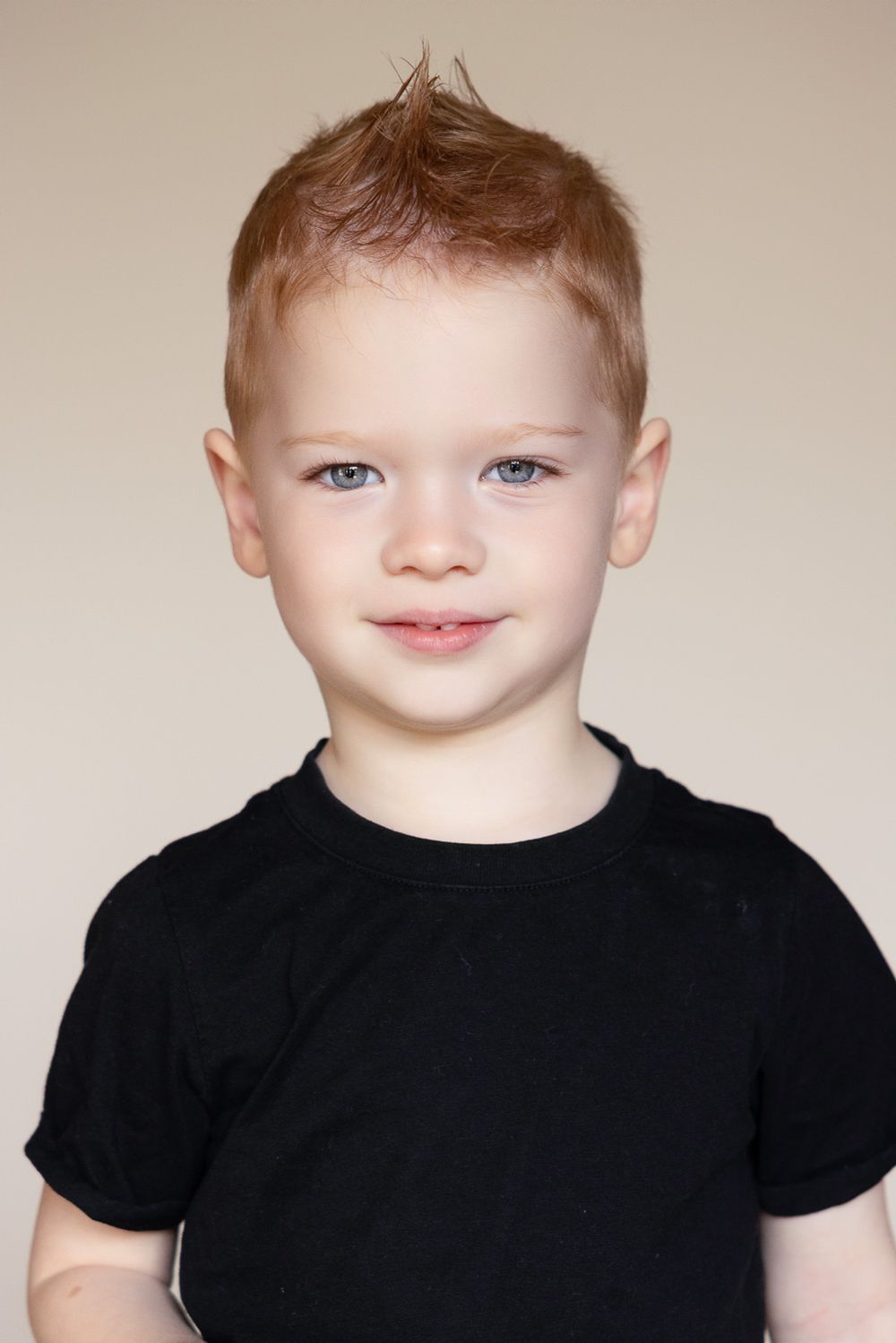 A child looks directly into the camera for his portrait at his preschool picture day in San Jose
