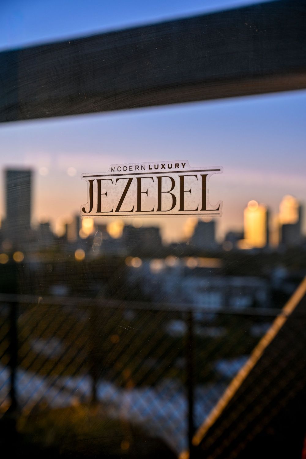 Blurred text reading 'Jezebel' appears in multiple frames against a darkening sky background at sunset.