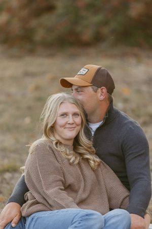 Cozy autumn portrait of a couple in casual sweaters and baseball caps.